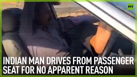 Indian man drives from passenger seat for no apparent reason