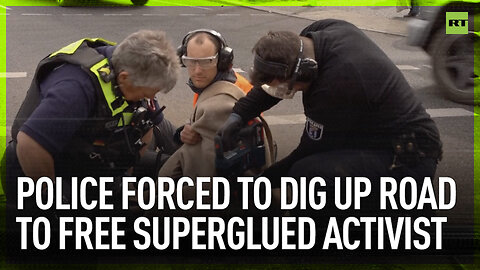 Police forced to dig up road to free superglued activist