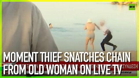 Moment thief snatches chain from old woman on TV