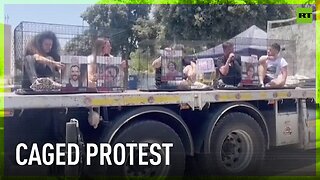 Relatives of Hamas hostages protest in cages outside Israeli parliament