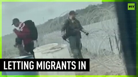 Border agent filmed destroying fence to allow migrants in