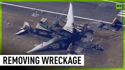Wrecked Japanese plane pulled apart at Haneda airport
