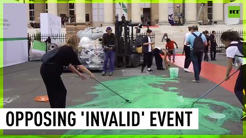 Eco-activists splash green paint in protest against Paris 'Greenwashing Summit'