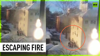 Several men save woman jumping for her life from burning apartment