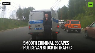 Smooth criminal escapes police van stuck in traffic
