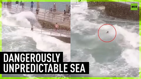 Moment girl is swept out to sea by fierce wave