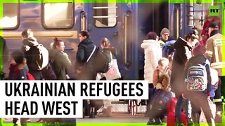 Ukrainian refugees board westbound buses in Przemysl, Poland