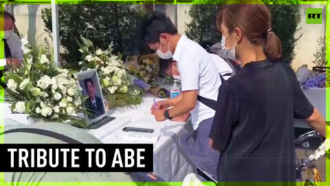 Mourners lay flowers in tribute to Shinzo Abe