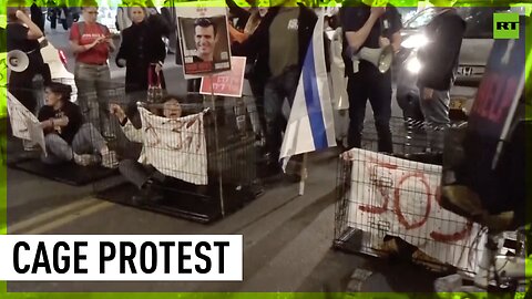 Protesters rally in cages calling for hostage deal in Tel Aviv