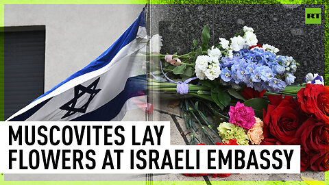 Moscow residents lay flowers at makeshift memorial outside Israeli Embassy