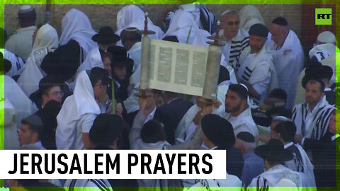 Jewish worshippers pray by Western Wall during Sukkot