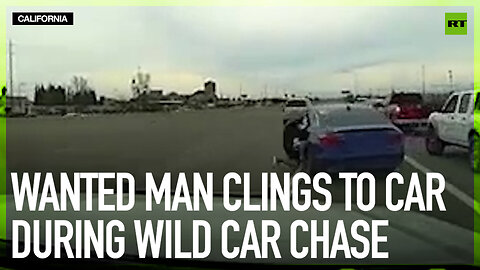 Wanted man clings to car during wild car chase