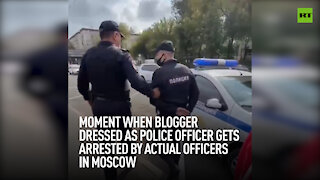 Moment when blogger dressed as police gets arrested by actual officers in Moscow