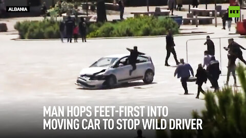 Man hops feet-first into moving car to stop wild driver