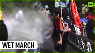 Indigenous Chileans soaked by water cannons at Columbus Day march