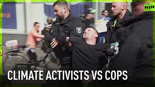 Police drag climate protesters off busy street in Berlin