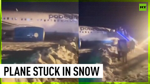 Airplane skids off runway, gets stuck in snow