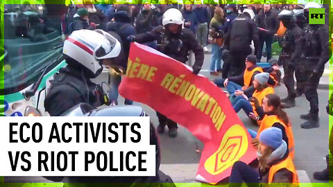 Police confront environmental activists blocking street in Paris