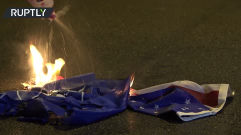 Anti-NATO membership protesters burn US and alliance flags near American embassy in Athens