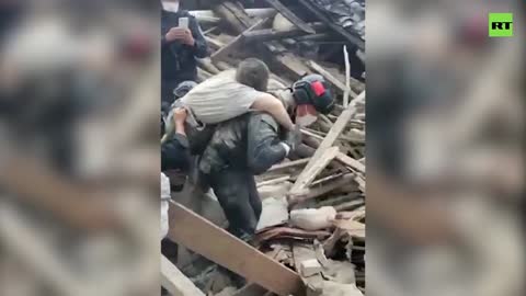 Police dig through earthquake debris with bare hands to rescue trapped man