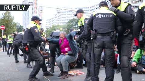XR activists attach themselves to vehicles at protest in The Hague