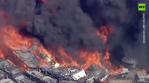 Dozens of cars on fire at scrap yard in California