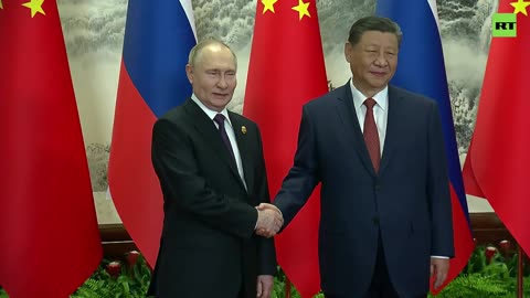 Putin and Xi pose for a photo ahead of talks in Beijing