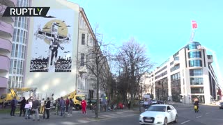 Giant mural depicting Assange nailed to a cross unveiled in Berlin