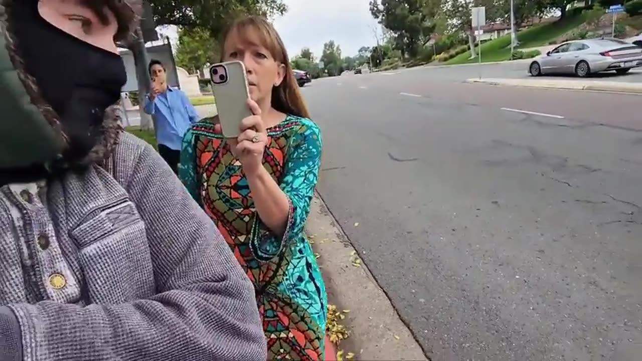 Insane people chase after a guy recording on the sidewalk