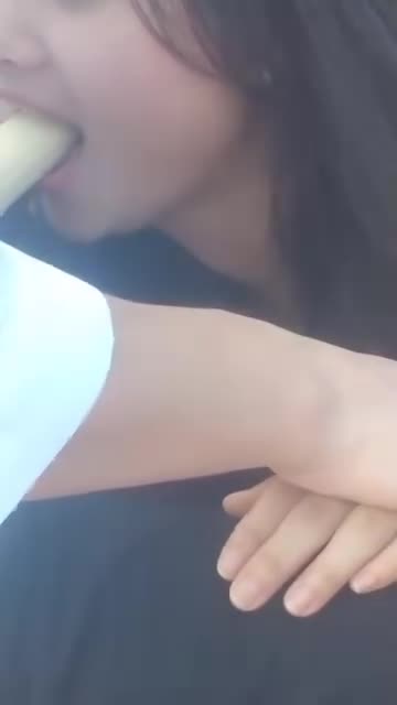 Cute Asian girl eating a banana