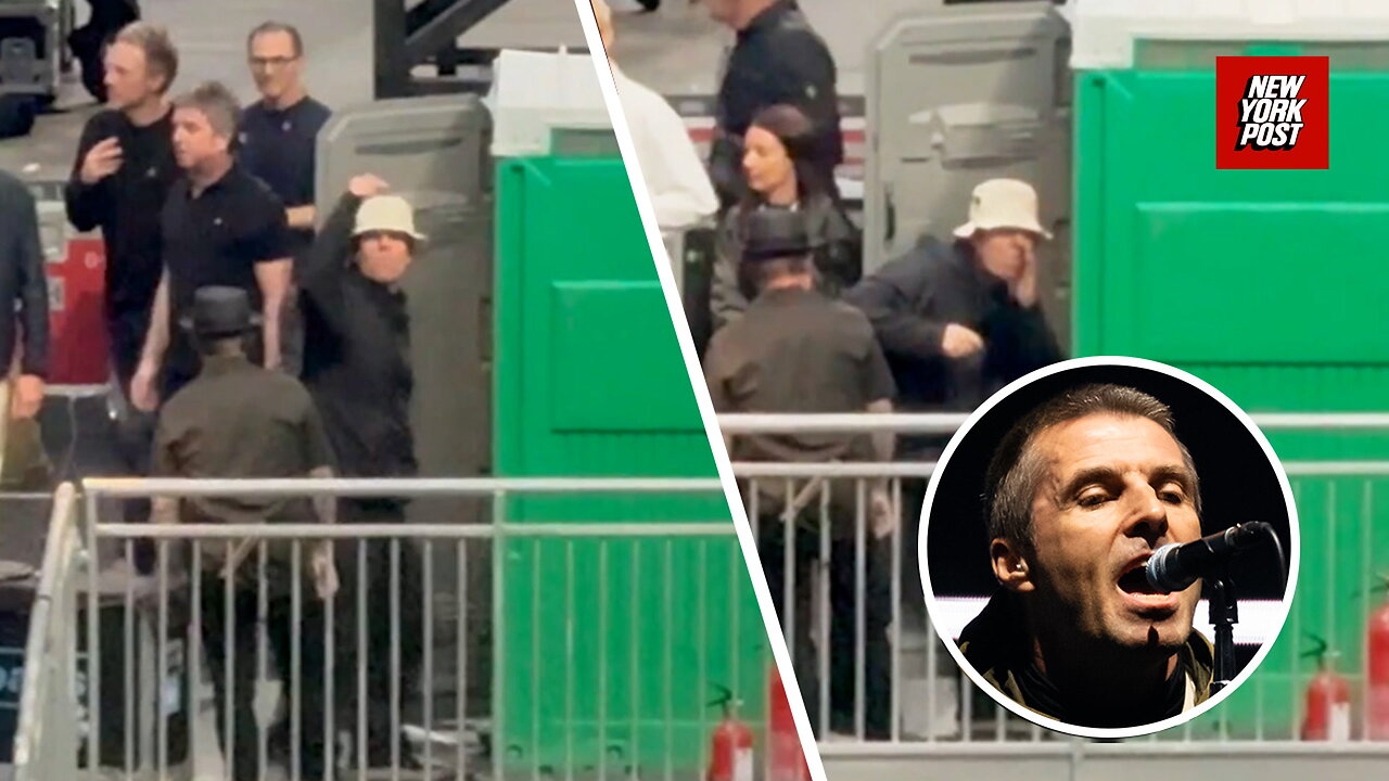 Oasis frontman Liam Gallagher jokingly gestures to fans that hes snorting drugs in a porta-potty