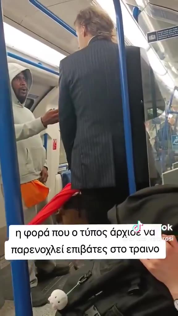 A man on the Victorian Underground line threatens two well dressed men