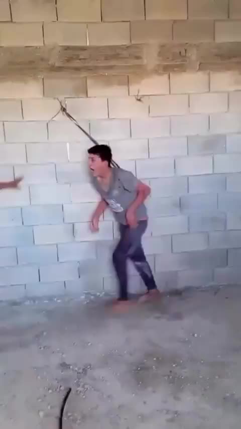 In Gaza, a Palestinian boy with special needs was tied to a wall by his..