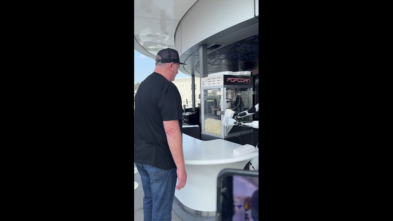 Teslas Optimus robot is seen serving popcorn at the newly opened Tesla Diner in Hollywood, CA