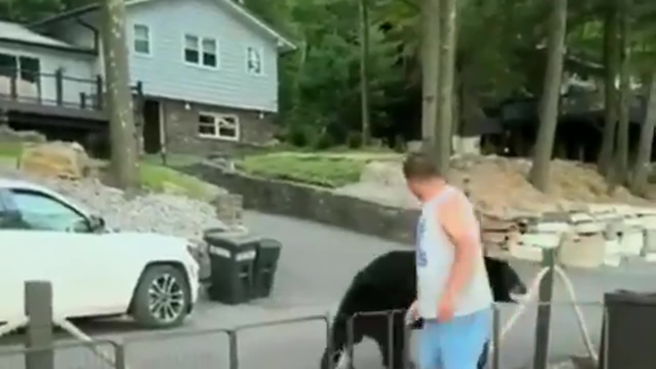 Man tells bear hes not invited and has to leave.