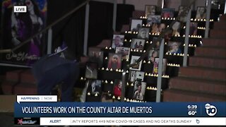 Volunteers work on Altar De Muertos at San Diego County building