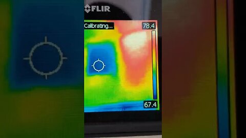 Home inspector using thermal imaging to spot missing insulation in home to save energy