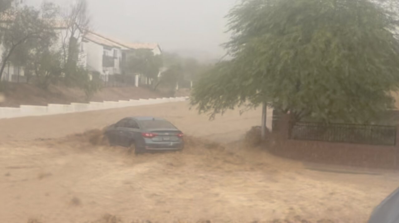 Pregnant womans car swept away by flood waters in east Las Vegas