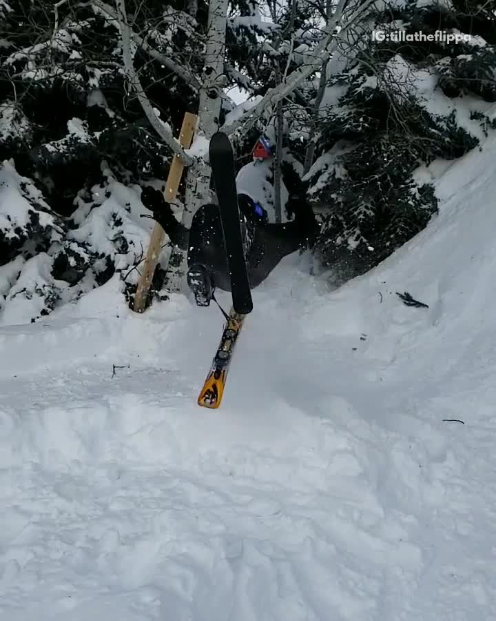 Skier backflips off small ramp, ski flies off right foot
