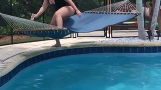Woman Trying to Relax Flips in Poolside Hammock